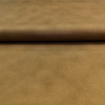 Primer plano de tela de algodón color ocre mostaza con estampado de puntos circulares pequeños en color crema para costura y acolchado